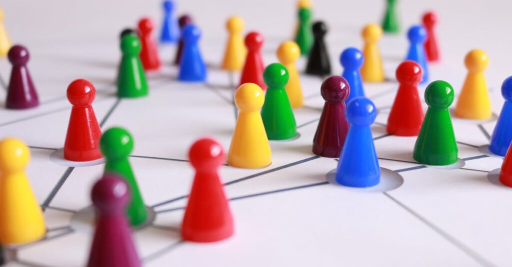 A strategic arrangement of colorful pawns connected on a game board, symbolizing networking and teamwork.